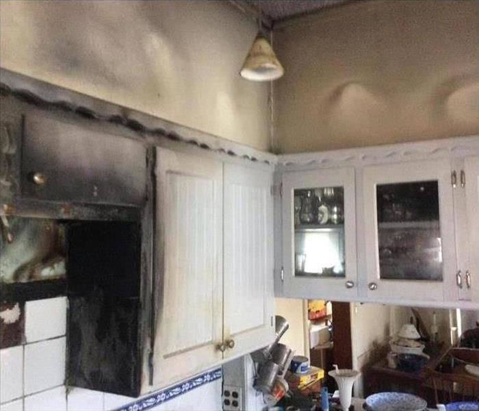 Cabinets with smoke damage, kitchen damaged by fire.